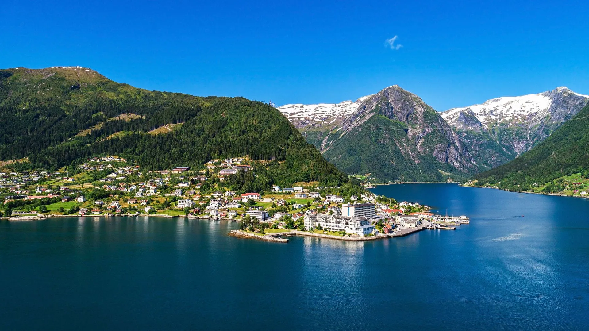 Scenic fjord village with mountains and blue water