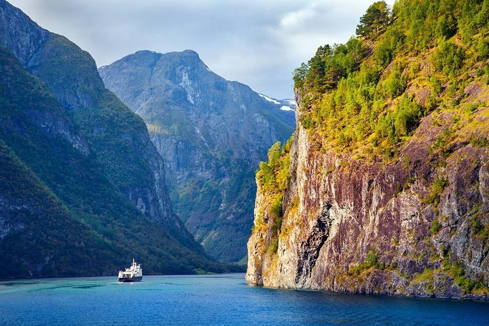 Ferry sailing through scenic mountain fjord