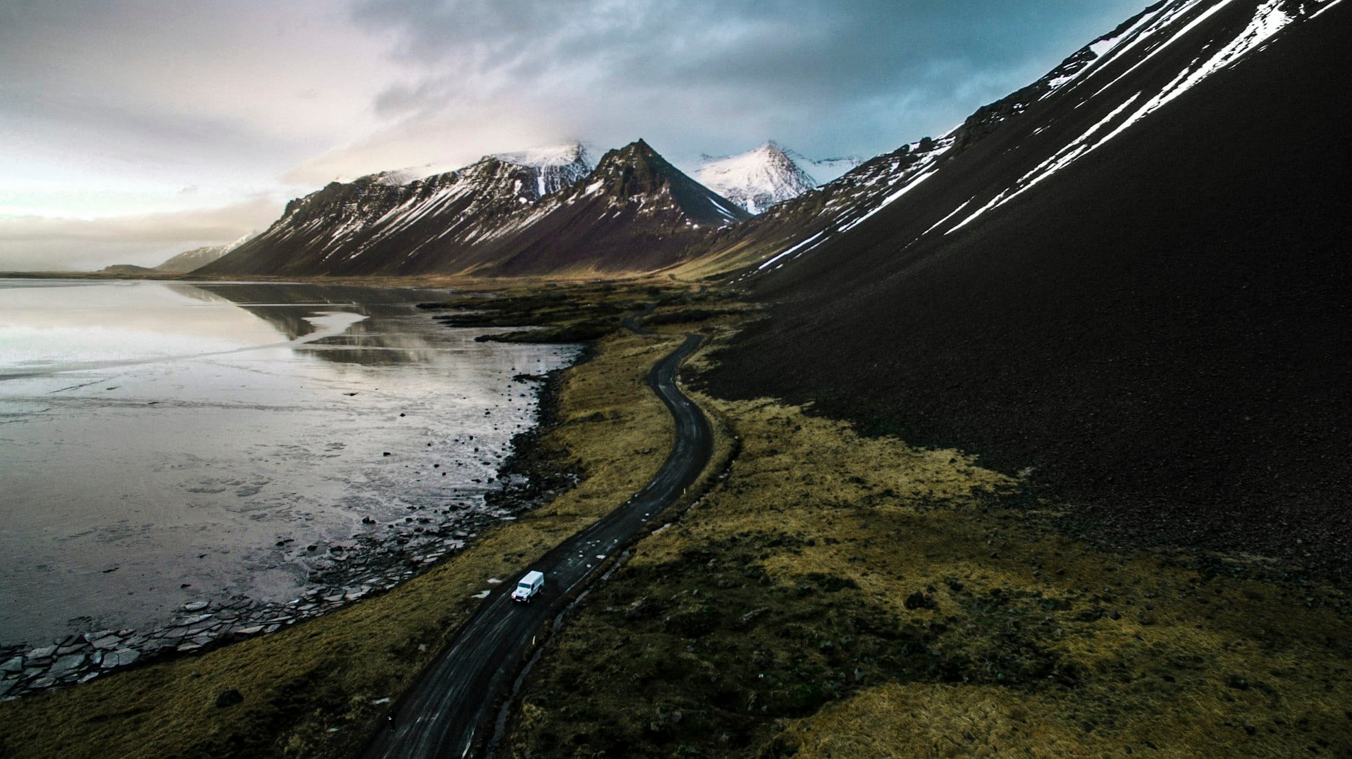 Car driving along coastal mountain road